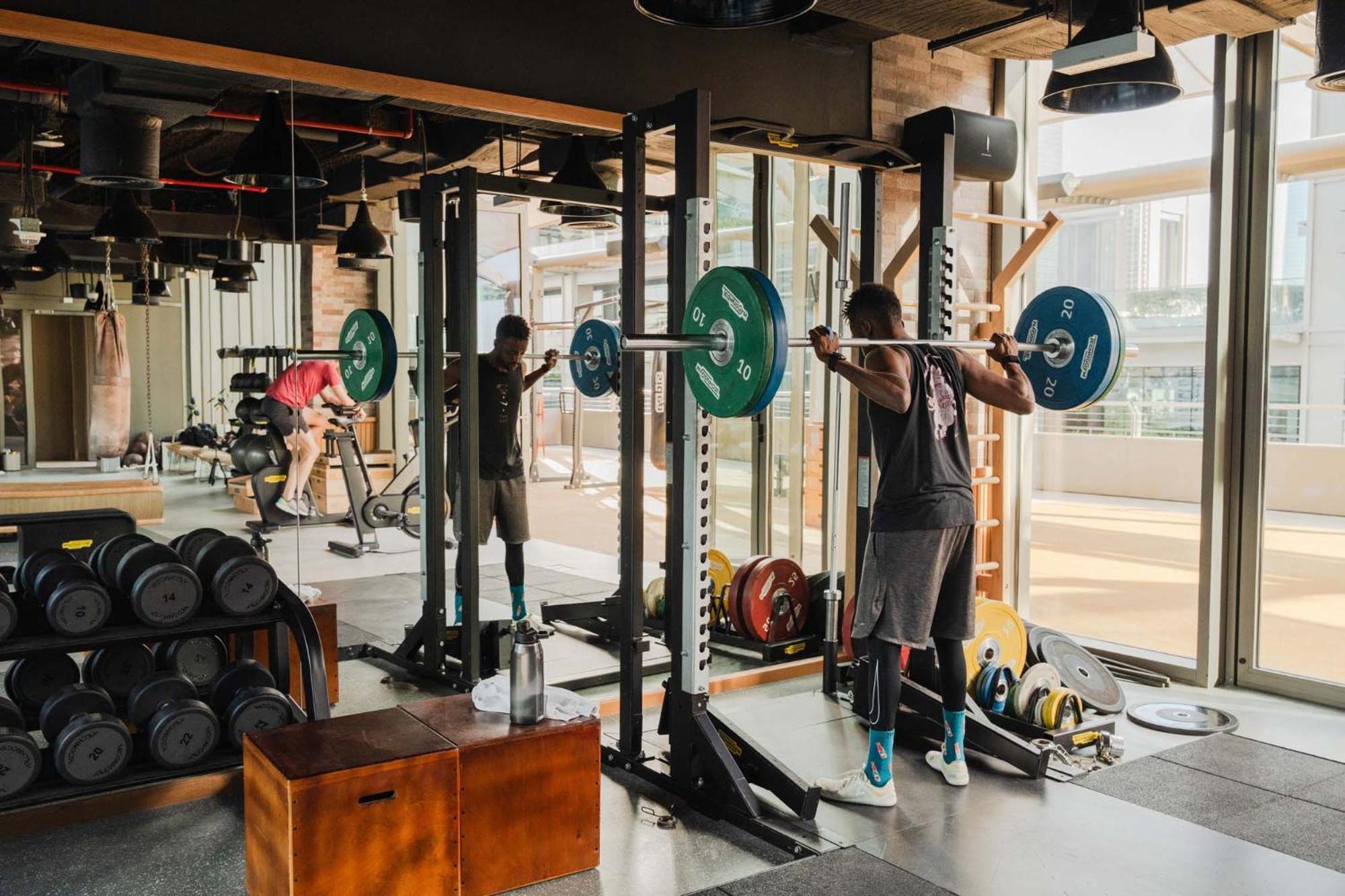 25Hours Hotel Dubai One Central Exterior photo A man doing a squat with a barbell